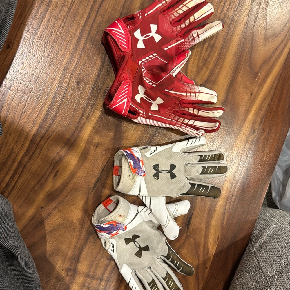 Two pairs of under Armour football gloves size small